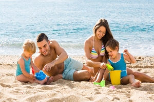 Family playing in the sand.