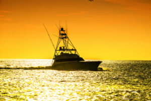 Sunset photo of a boat on the water during one of the boat tours in fort myers beach