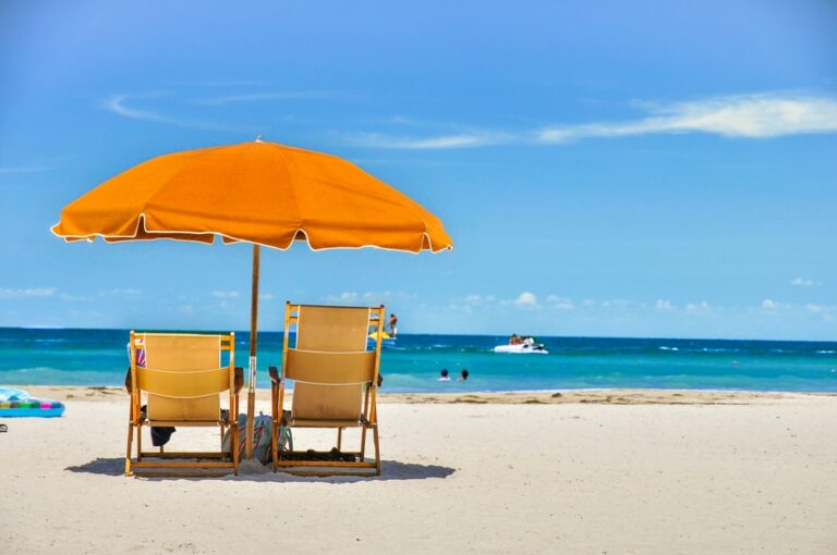 beach chairs with umbrellas by the water during a Florida summer vacation